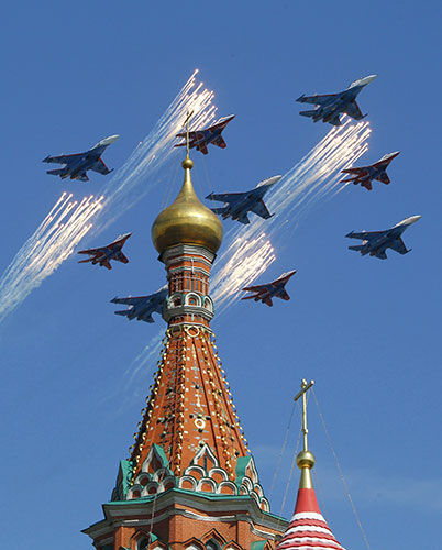 Victory parade: A group of Russian fighters fly in formation over St Basil's Cathedral