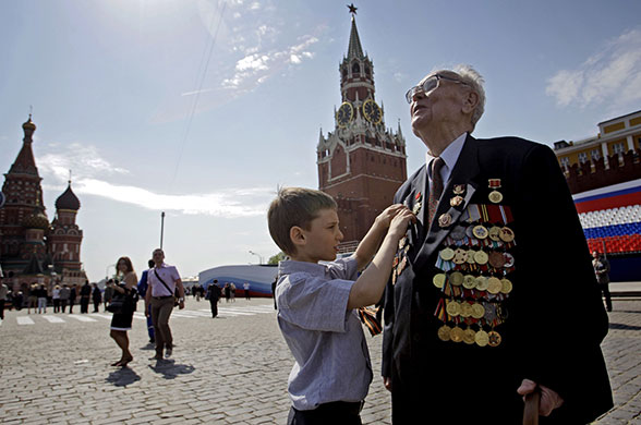 Victory parade: A boy inspects the medals of a Russian Second World War veteran