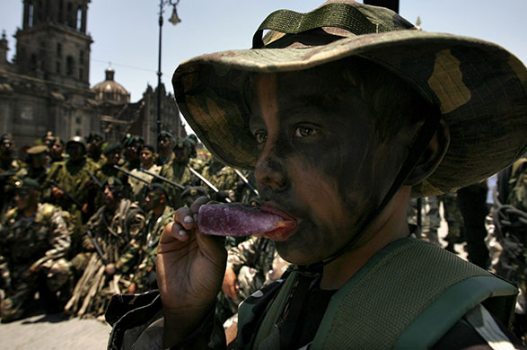24 hours: Mexico City, Mexico: A child in military gear at a parade