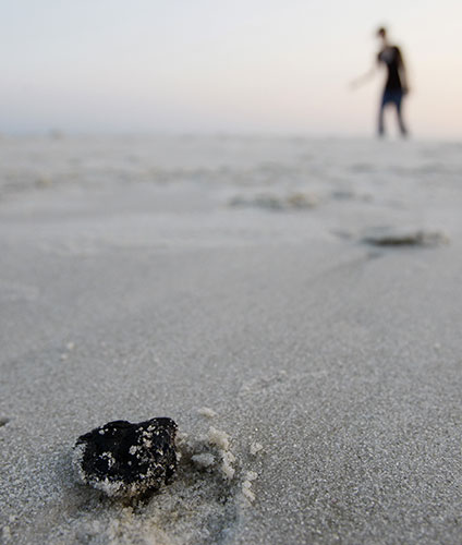 24 hours: Dauphin Island, USA: A chunk of tar is seen on a beach in Alabama