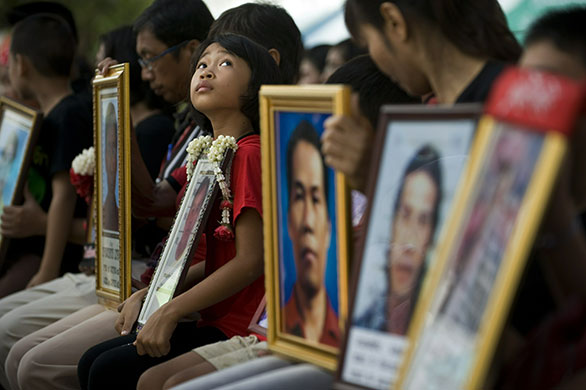 24 hours: Bangkok, Thailand: Relatives of demonstrators who died hold their pictures