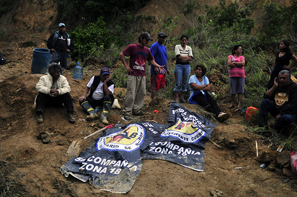 Guatemala storm: 30 May: Friends and relatives next to the bodies of two victims
