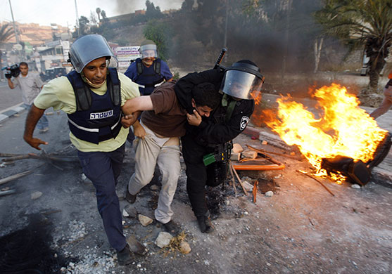 Israel protests: An Israeli Arab youth is detained by police during minor clashes