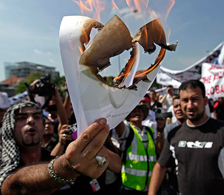 Israel protests: Protesters burn a photograph of Netanyahu in Kuala Lumpur