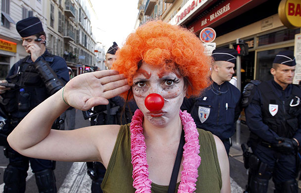24 hours in pictures: Nice, France: A demonstrator salutes in front of police