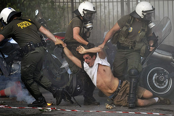 24 hours in pictures: Athens, Greece: Police drag a protestor