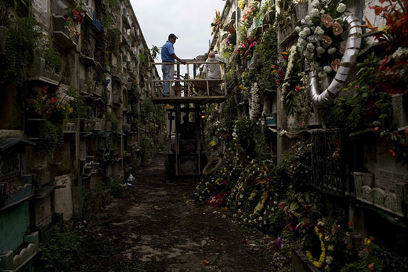 24 hours in pictures: Guatemala City, Guatemala: Workers clean niches at the main cemetery