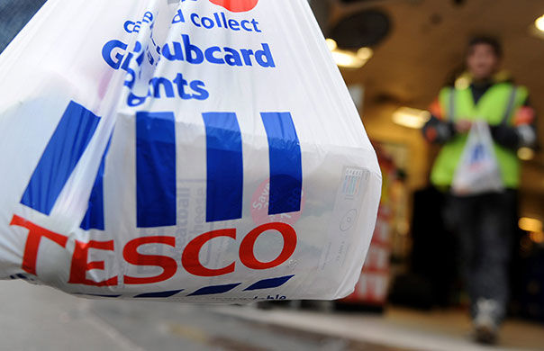 Week in Business: A customer leaves a Tesco supermarket in central London