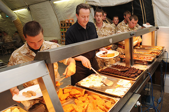 Cameron in Afghanistan: David Cameron carries his plate at breakfast