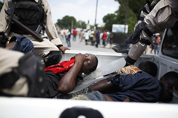 24 hours in pictures: Port-au-Prince, Haiti: An injured protester