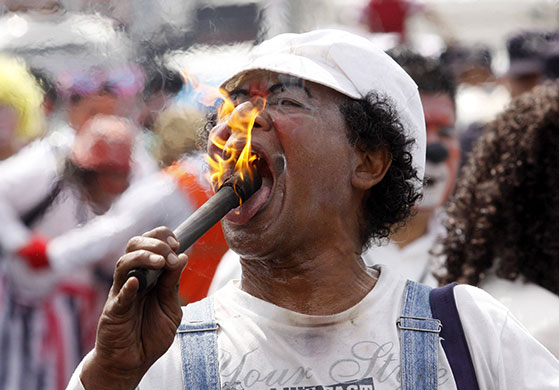 24 hours in pictures: A clown demonstrates during a protest in San Salvador