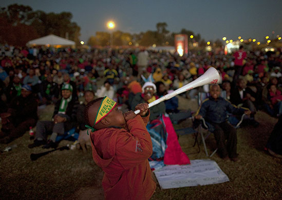 24 hours: Johannesburg, South Africa: A Nigerian boy blows a vuvuzela
