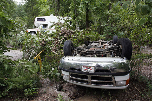 Arkansas floods: An overturned van and a damaged vehicle near the Little Missouri river