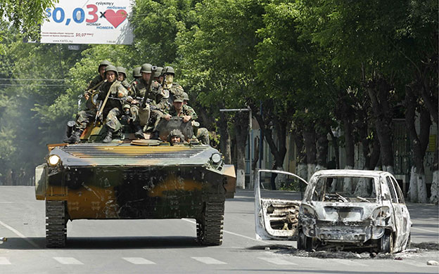 Kyrgyzstan violence: Government troops in an APC patrol the streets of  Osh