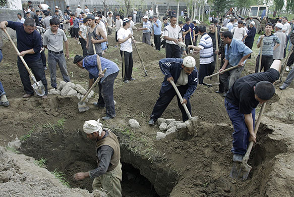 Kyrgyzstan violence: Uzbek men prepare the graves for the victims of the ethnic clashes