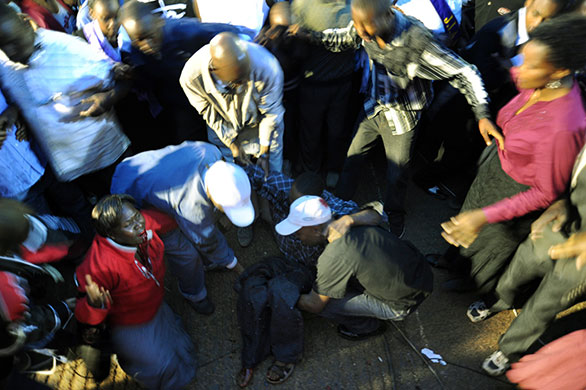 Kenya explosion: People assist blast victims at Kenya's Uhuru Park in the capital Nairobi