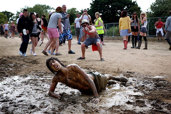 Isle of Wight: Isle of Wight Festival goer Tom Rowell gets muddy