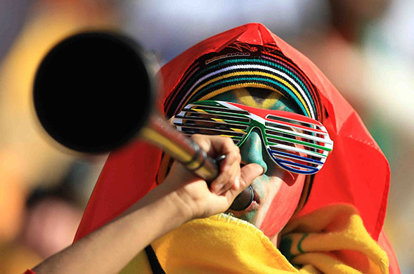 World Cup vuvuzelas: South Africa fan blows a Vuvuzela