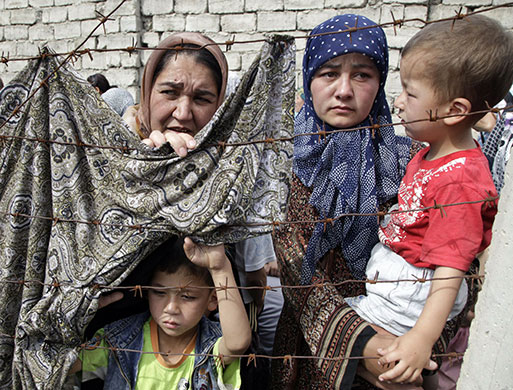 Uzbek refugees: A refugee waits at the Kyrgyz-Uzbek border outside the village of Suratash