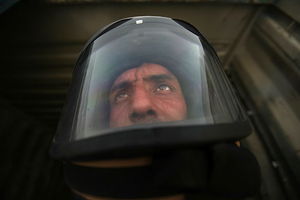 24 hours in pictures: A member of a US Army Explosive Ordnance Disposal team