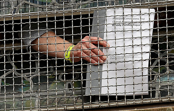 Bloody Sunday Inquiry: People hold copies of the Saville Inquiry report into Bloody Sunday