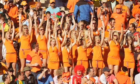 Women in orange dresses at the Holland v Denmark World Cup match on Monday