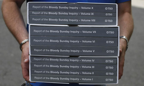 A person carries a copy of the Saville Inquiry report into Bloody  Sunday