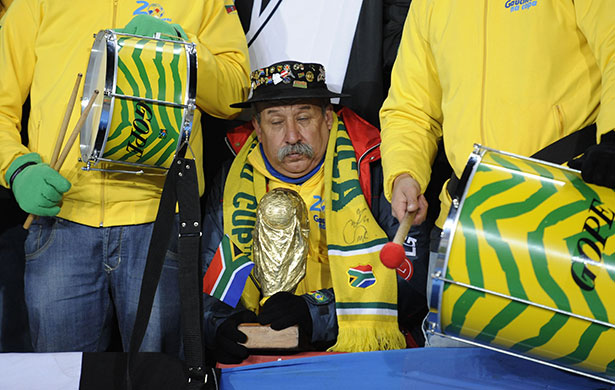 Brazil v North Korea: Brazil fan sitting between two drums
