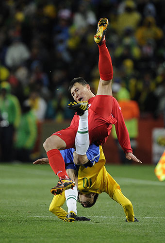 Brazil versus North Korea: Pak Chol Jin and Kaka fall to the ground