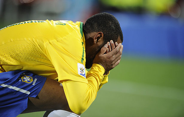 Brazil versus North Korea: Robinho goes down clutching his face