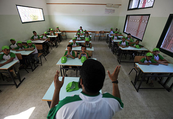 Summer Camp: A trainer helps Palestinian boys chant slogans during a summer camp