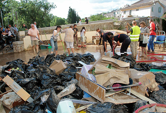 France Floods: Trans-en-Provence: People clean up a terrace in the aftermath of flooding