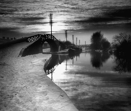 Longden's Canals: A stark landscape showing a snow covered foot-bridge