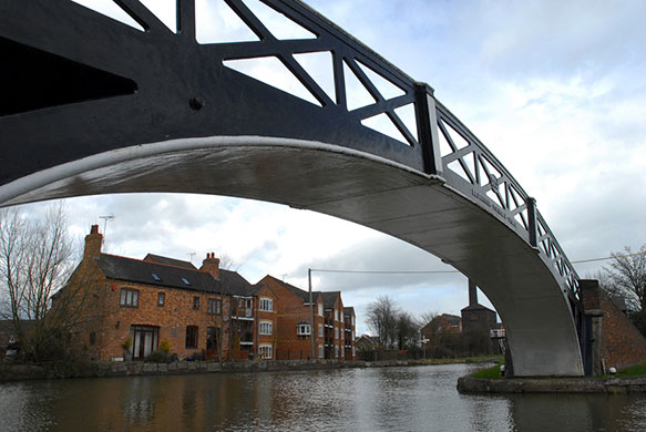 Longden's Canals: A wrought iron bridge frames a view of a new canal-side building