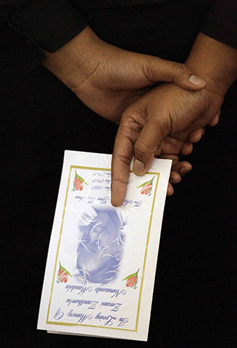 Zenani Mandela memorial: A mourner holds a card during the memorial of Zenani Mandela 