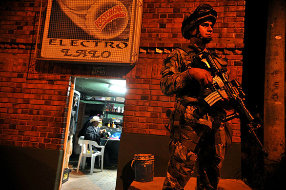 24 hours in pictures: Bogota, Colombia: A soldier stands guard during security operations