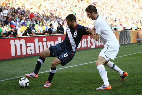 USA v Slovenia: USA's Clint Dempsey is challenged by Bostjan Cesar of Slovenia