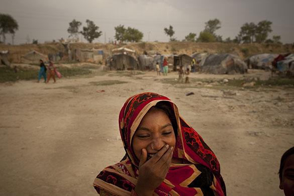 24 hours in pictures: Islamabad, Pakistan: A girl smiles in a poor neighbourhood
