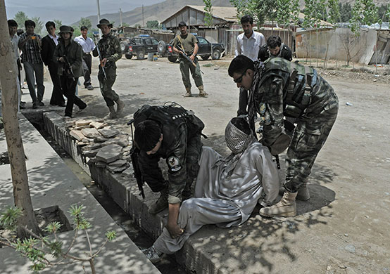 24 hours in pictures: Kabul, Afghanistan: Security forces detain a subject following clashes