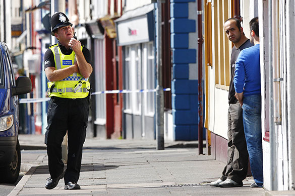 Cumbria shootings: A police officer near the scene of the shooting on Duke Street in Whitehaven