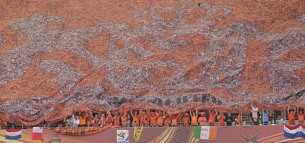 World Cup day 10: The Netherlands' fans cheer from underneath a large banner