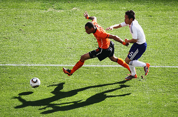 World Cup day 10: Gregory Van Der Wiel sprints clear of Yuto Nagatomo