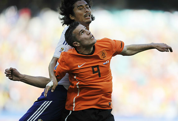 World Cup day 10: Robin van Persie is out-jumped by Japan defender Yuji Nakazawa 