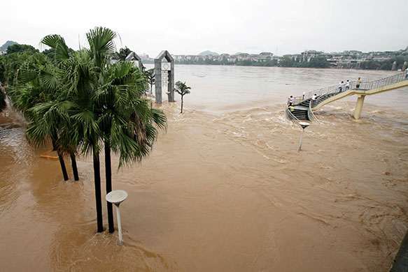 Chian flooding: Chinese residents gather to watch as flood waters swell from the Li river