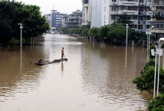 Chian flooding: A man watch from his raft over a flooded neighborhood in downtown Guilin