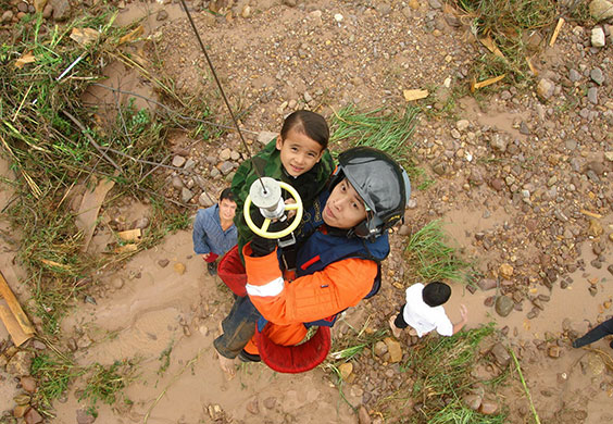 Chian flooding: A Chinese airforce personnel holds on to child during airlift, China