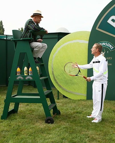 Wimbledon day one: John McEnroe poses for photos