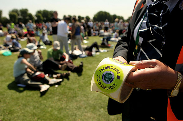 Wimbledon day one: A steward hands out 