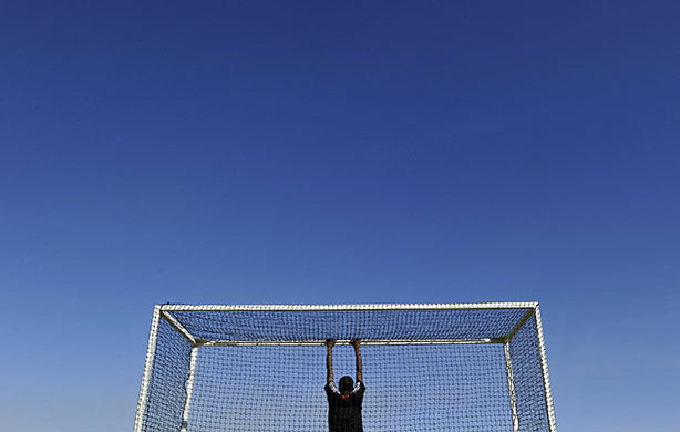 24 hours in pictures: TOPSHOTS A local boy stands in the goal