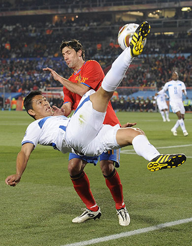 Spain v Honduras: Roger Espinoza spectacularly clears from Joan Capdevila 
